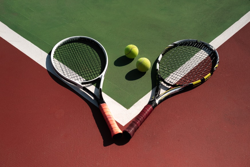 Tennis court with rackets and balls